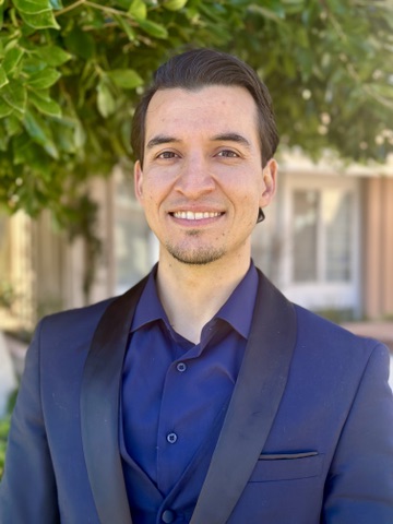 Portrait of Kareem Jamal wearing a navy suit